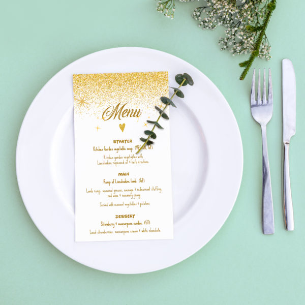 Dinner menu for a wedding or luxury evening meal. Table setting from above. Elegant empty plate, cutlery and flowers.