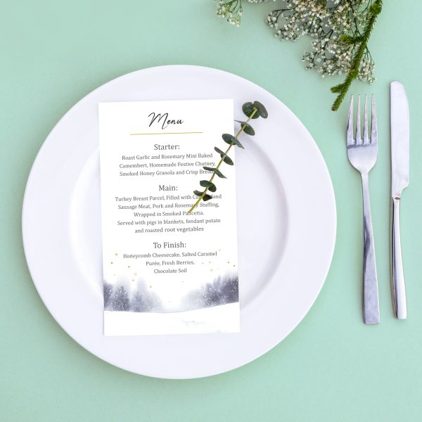 Dinner menu for a wedding or luxury evening meal. Table setting from above. Elegant empty plate, cutlery and flowers.